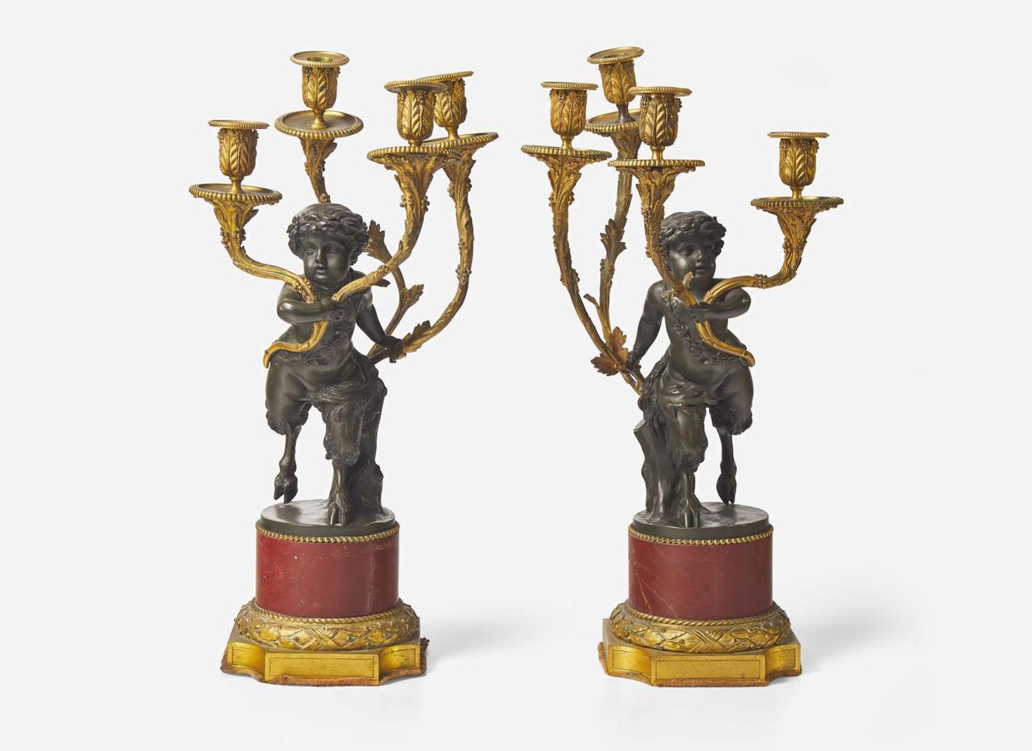 A pair of Louis XVI style gilt and patinated bronze candelabras depicting fauns, late 19th century