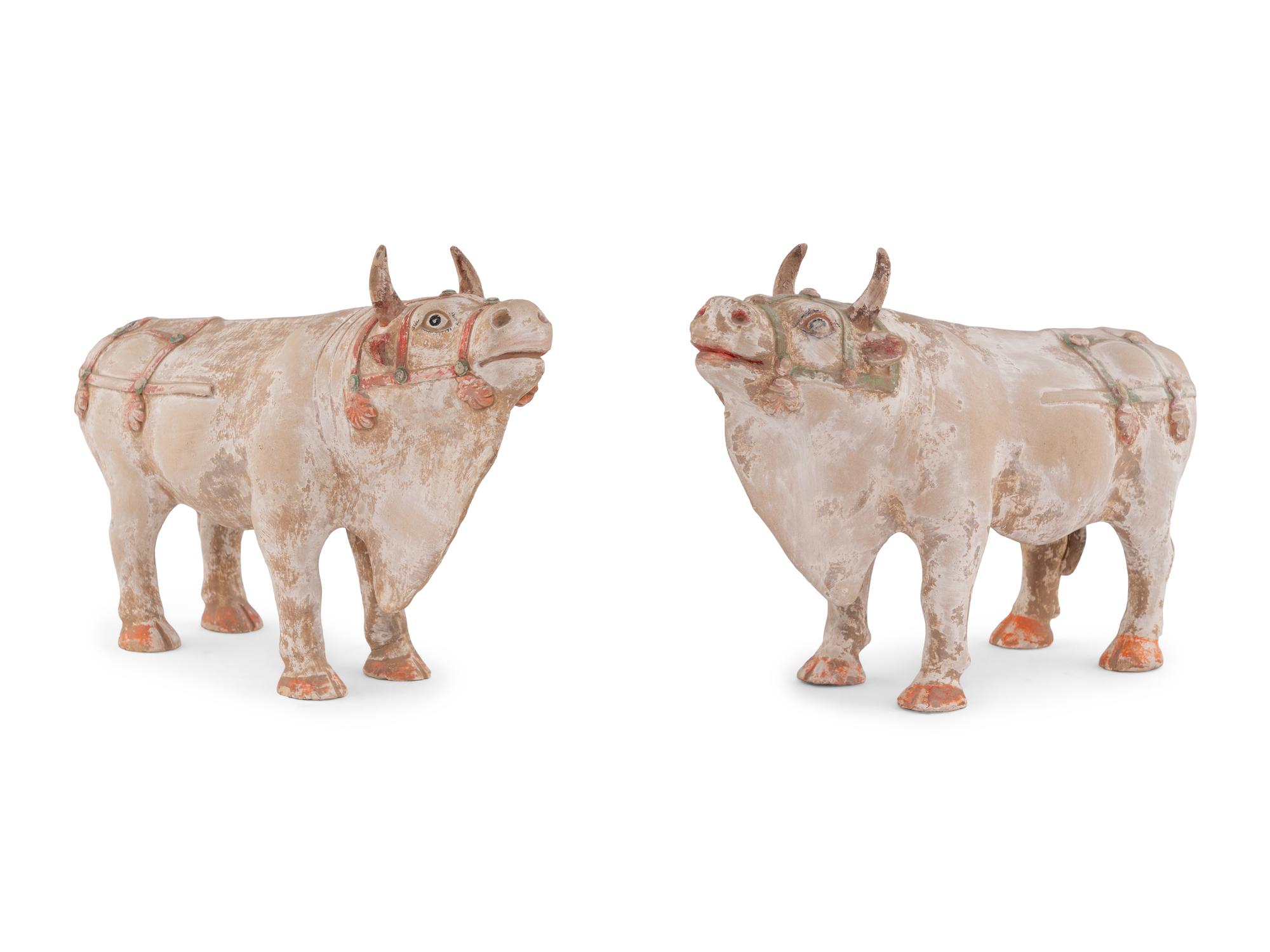 A Pair of Chinese Painted Pottery Figures of Oxen
