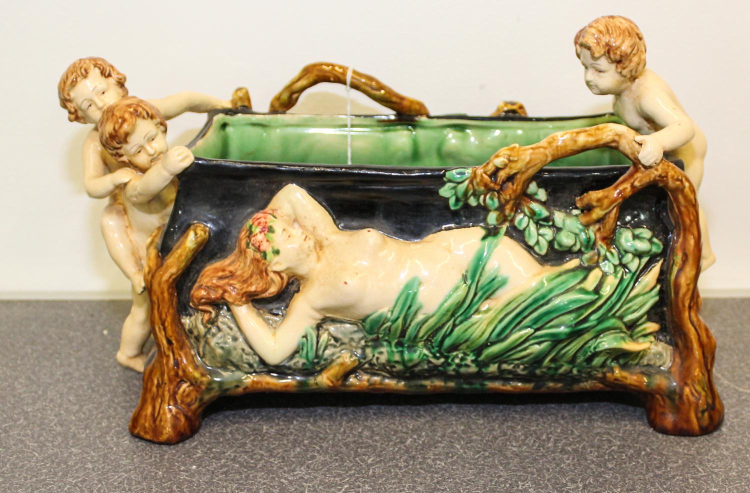 A Figural Jardiniere. Height 8 1/4 x length 13 x width 7 inches.
