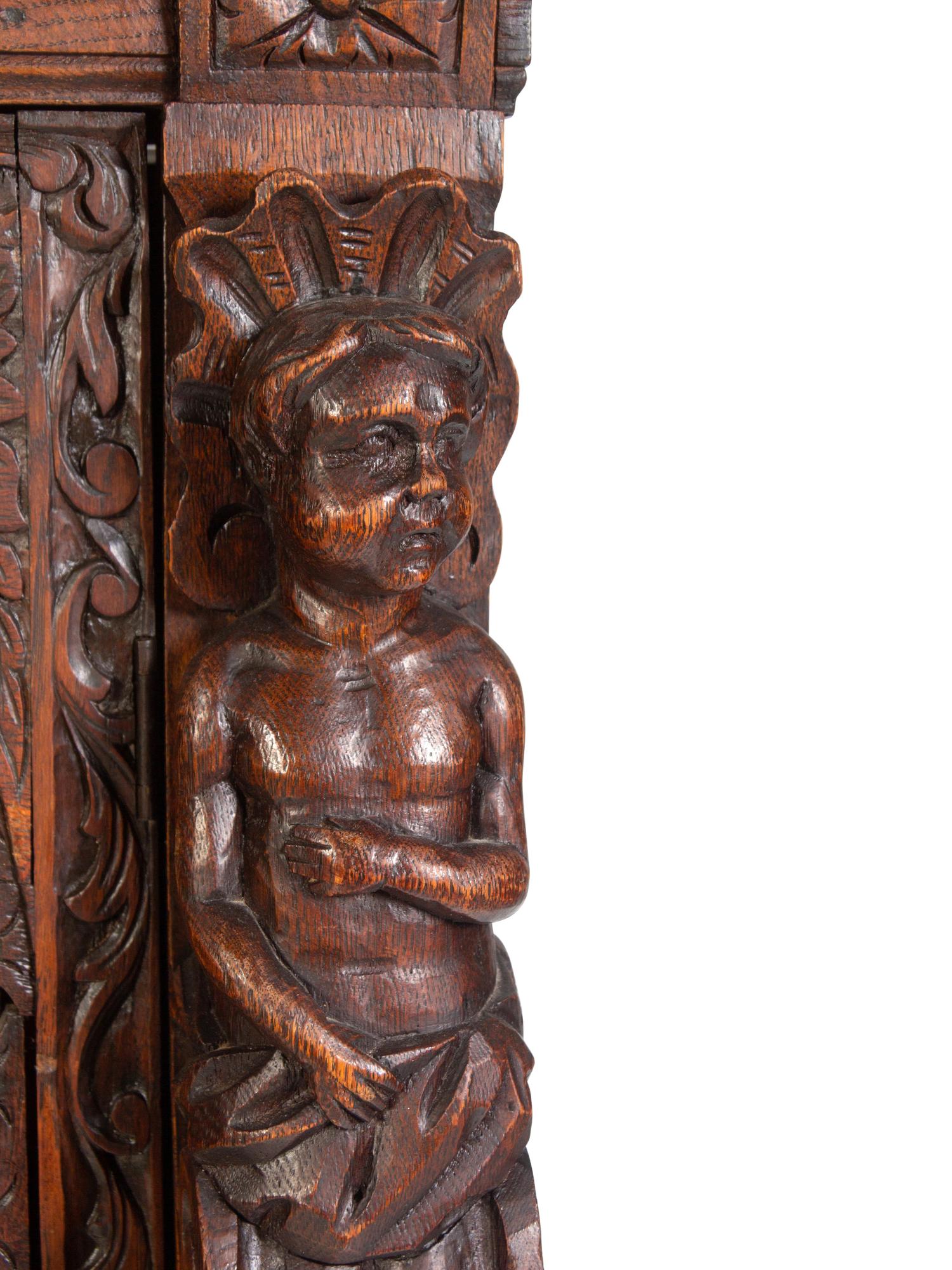 An Italian Renaissance Revival Carved Oak Cabinet