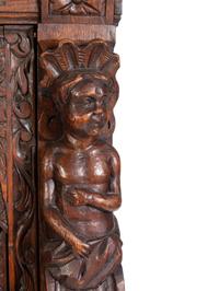 An Italian Renaissance Revival Carved Oak Cabinet