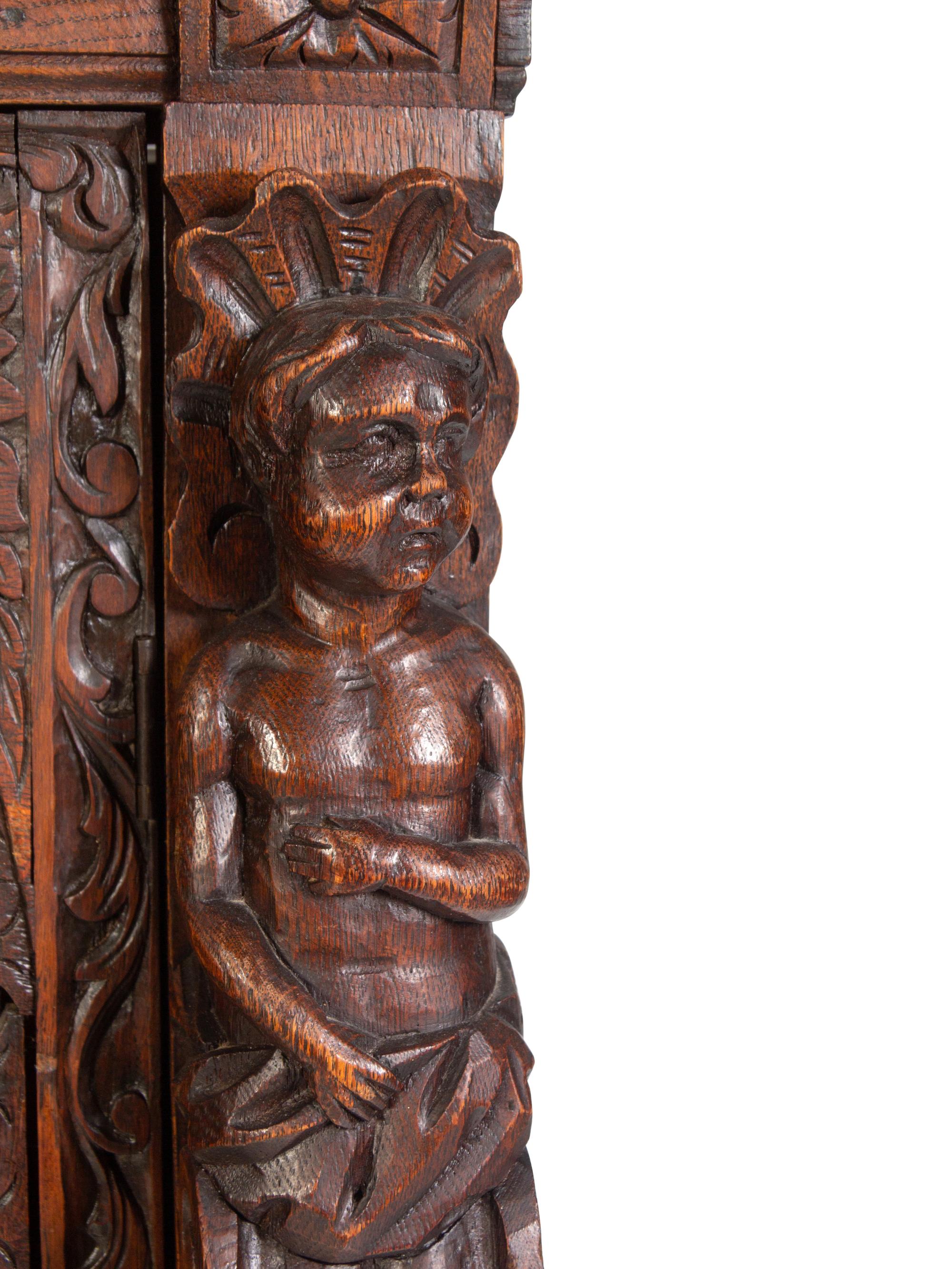 An Italian Renaissance Revival Carved Oak Cabinet
