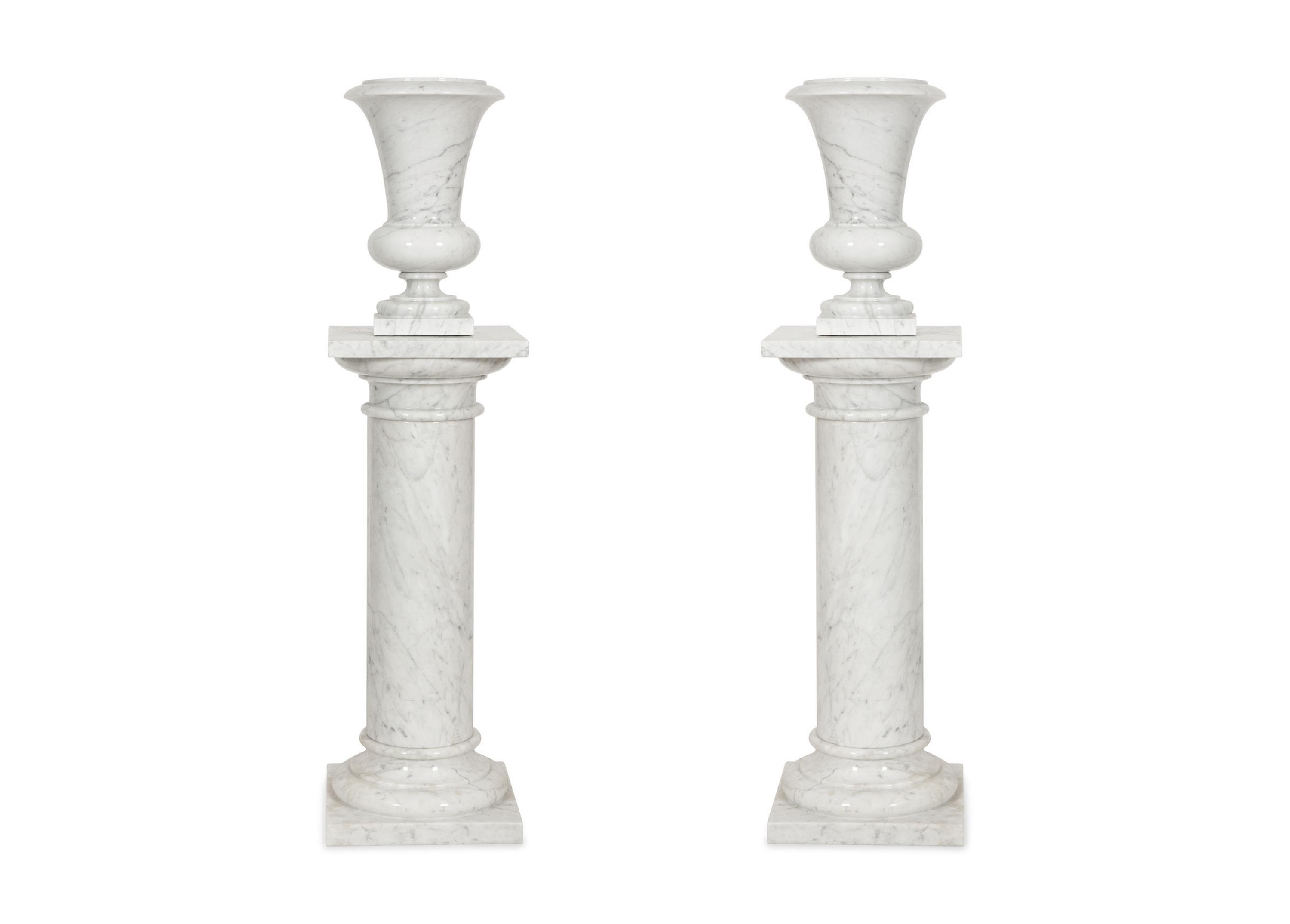 A Pair of White Marble Urns on Matching Pedestals