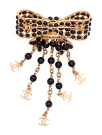 Six Chanel Brooches/Pins: Four Textile, One Snake Skin, One Metal