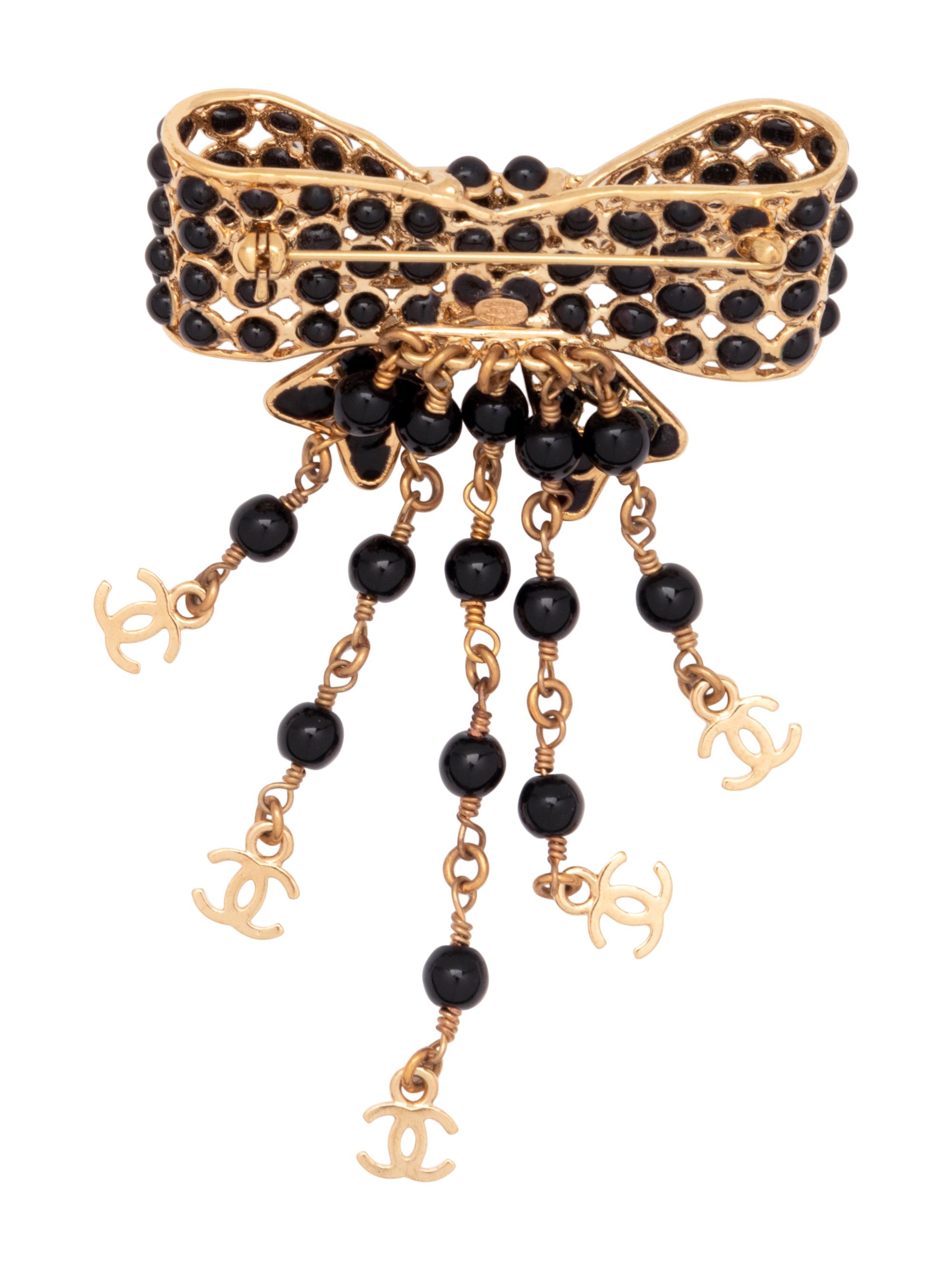 Six Chanel Brooches/Pins: Four Textile, One Snake Skin, One Metal