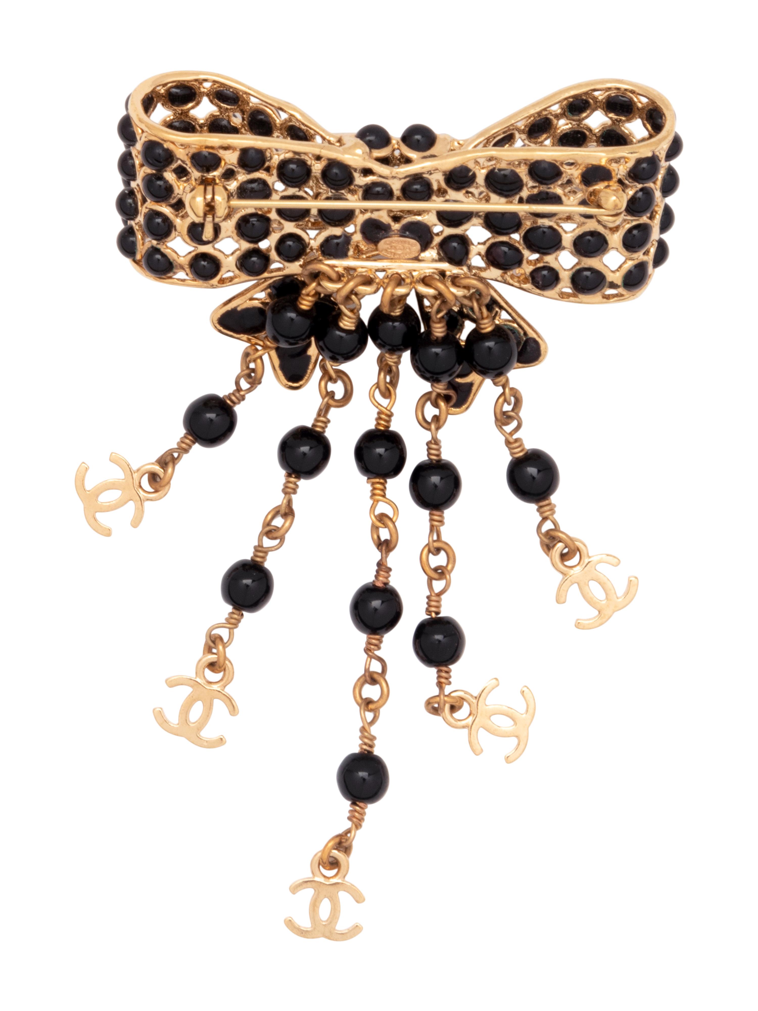 Six Chanel Brooches/Pins: Four Textile, One Snake Skin, One Metal