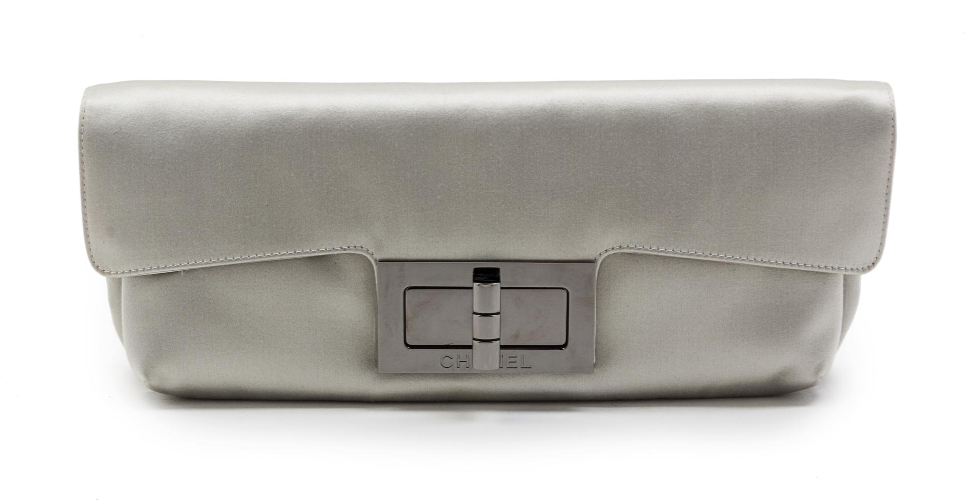 A Chanel Light Grey Satin Clutch, 12 1/2 x 5 x 2 1/2 inches.