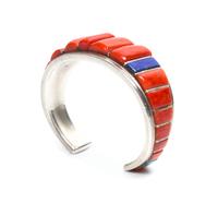 A Zuni Silver, Coral and Multi-Gem Bracelet, Roger Tsabetsaye Length 4 7/8 x opening 1 x width 3/4 inches.