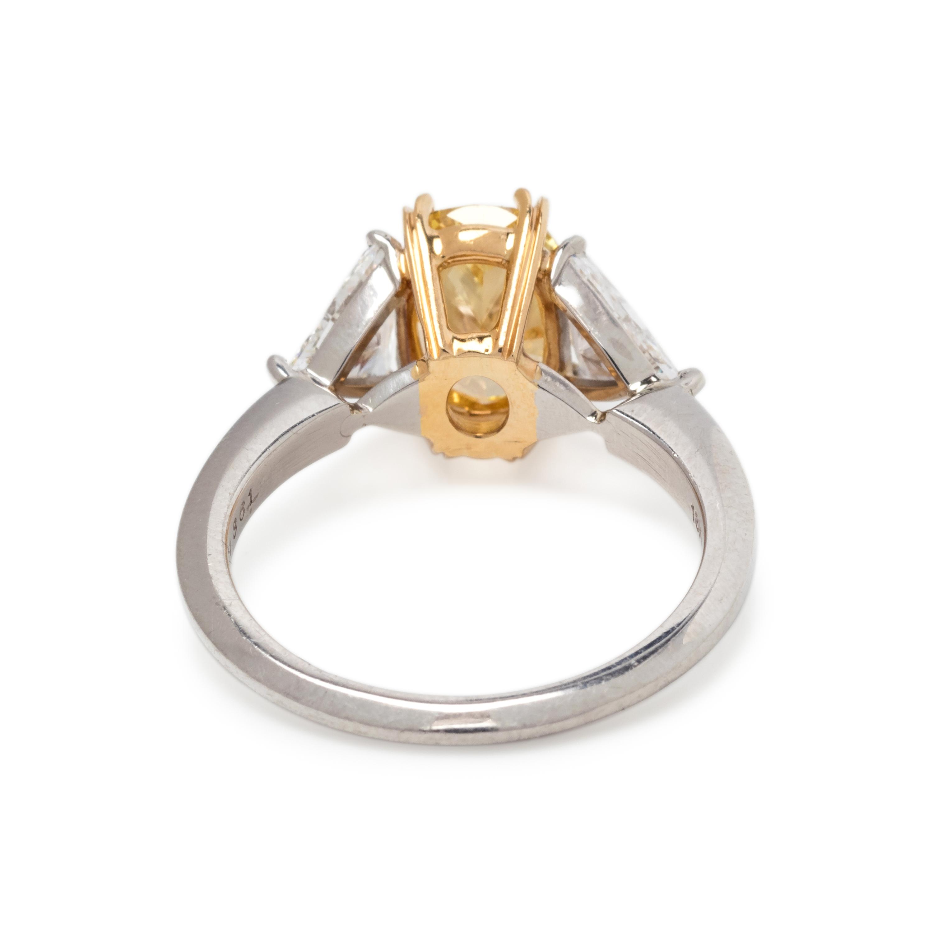 TREATED FANCY INTENSE YELLOW DIAMOND AND DIAMOND RING