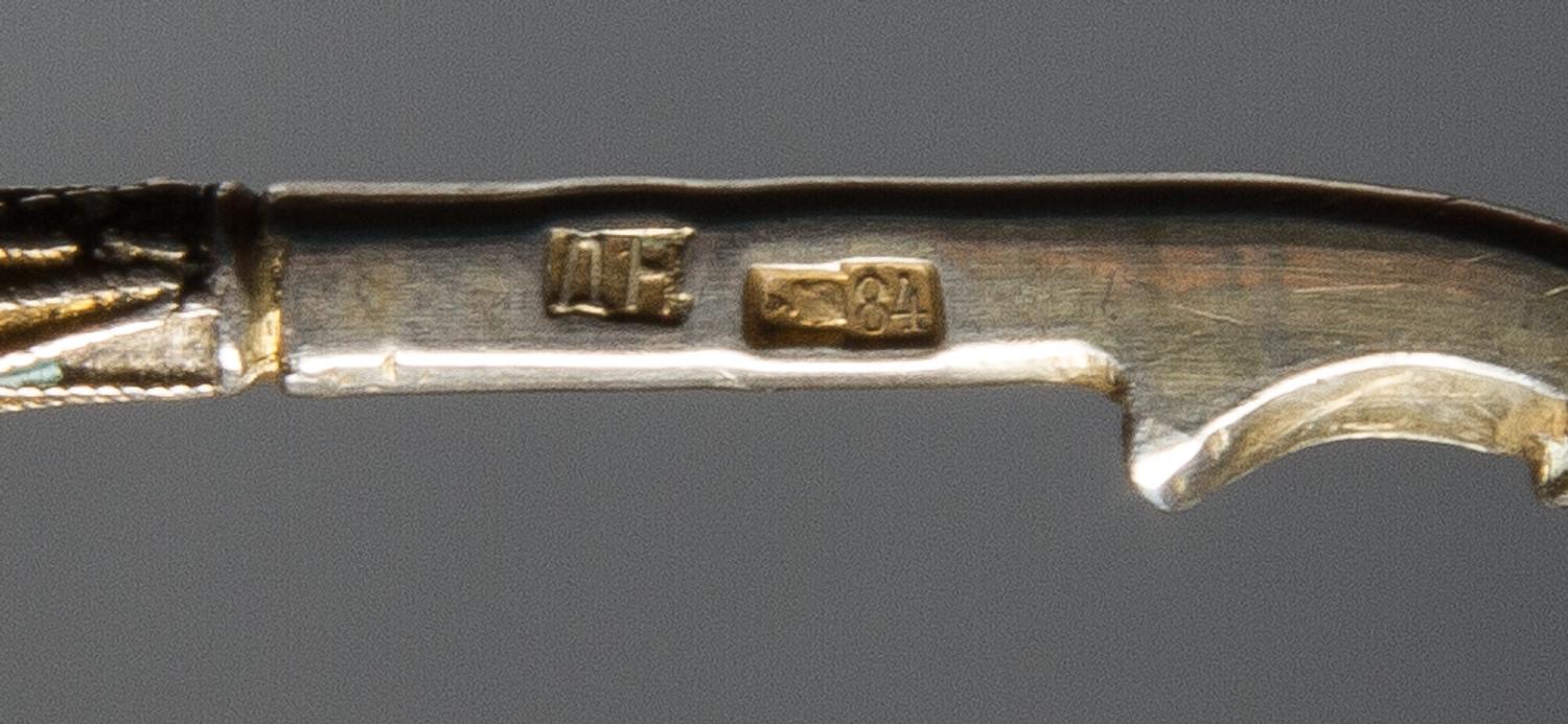 A Russian Silver and Enamel Spoon, Mark of D.P. Nikitin, Moscow, early 20th century, having an enamel finial, the underside of the bowl