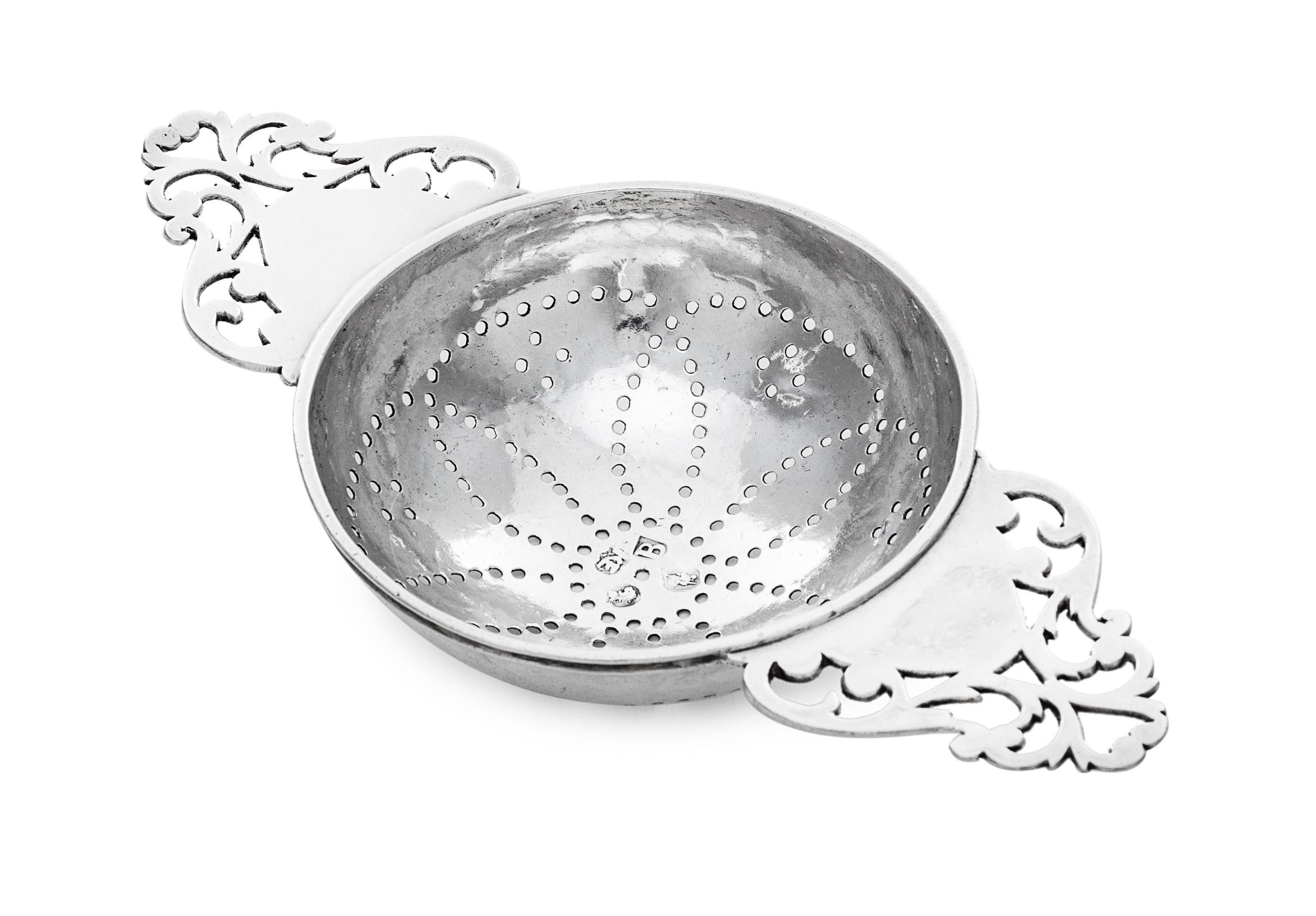 A George I Britannia Silver Lemon Strainer, Likely Robert Kempton, London, 1717, having twin openwork handles flanking the pierced bowl