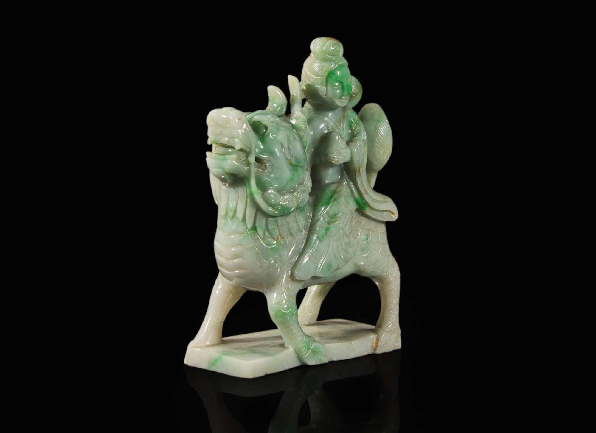 A Chinese jadeite figure of a meiren on a fabulous beast 翡翠雕仙人逸獸