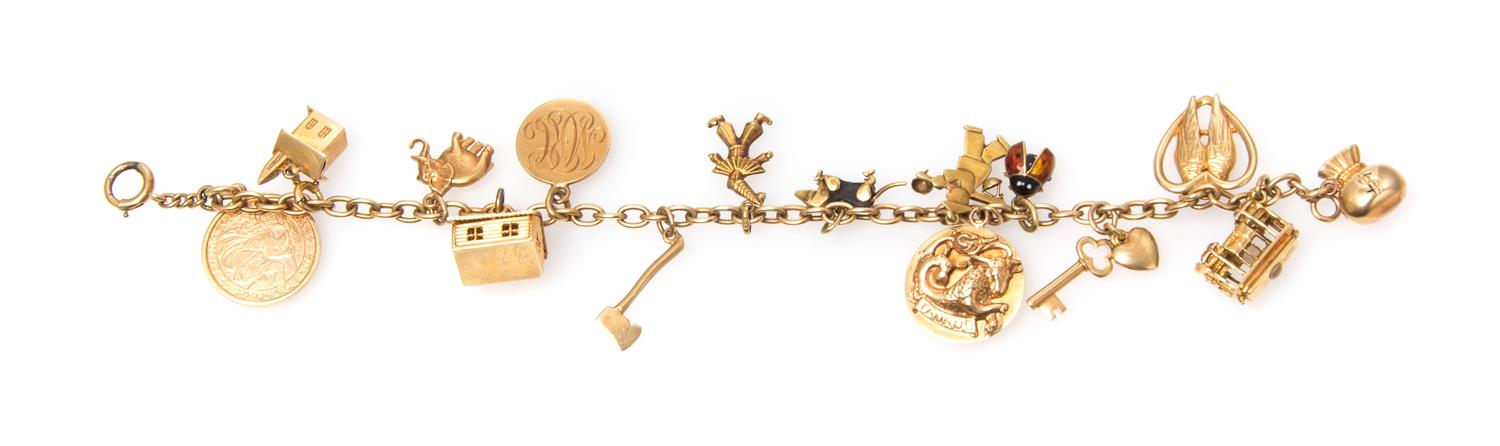 A Vintage 14 Karat Gold Charm Bracelet with 15 Attached Charms, 23.70 dwts.