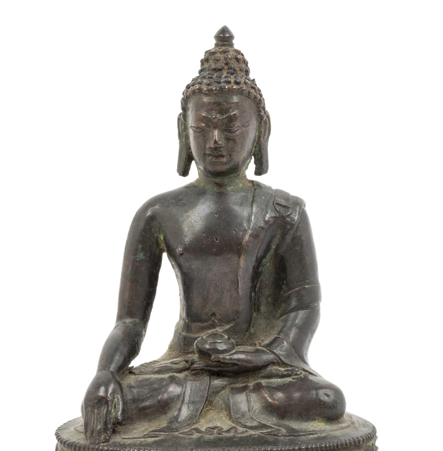 A Tibetan Bronze Figure of Seated Buddha Akshobhya