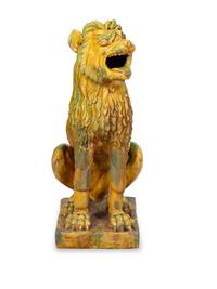 A Pair of Italian Yellow and Green Glazed Ceramic Figures of Seated Lions