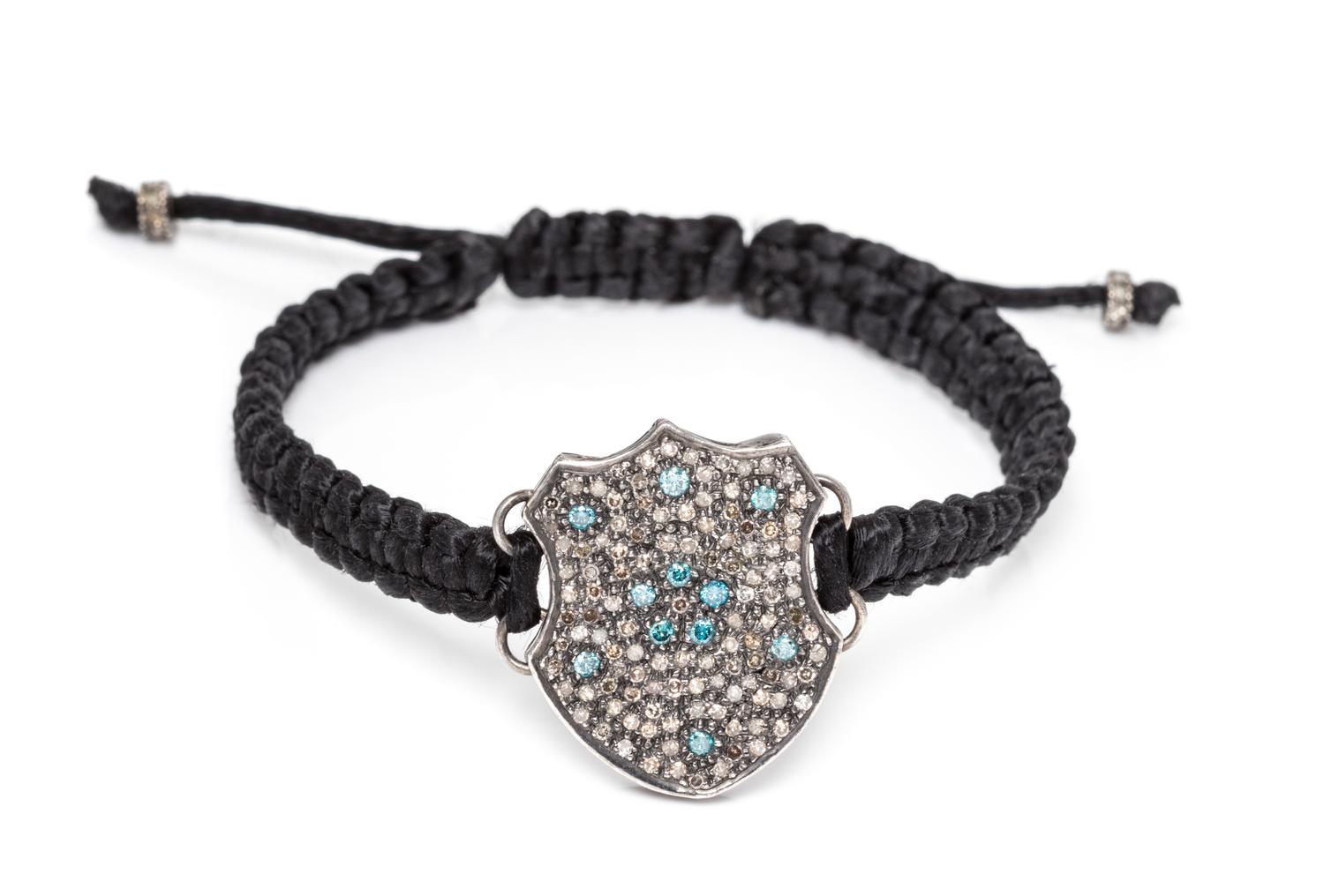 A Silver, Diamond and Treated Diamond Cord Bracelet, 5.80 dwts.