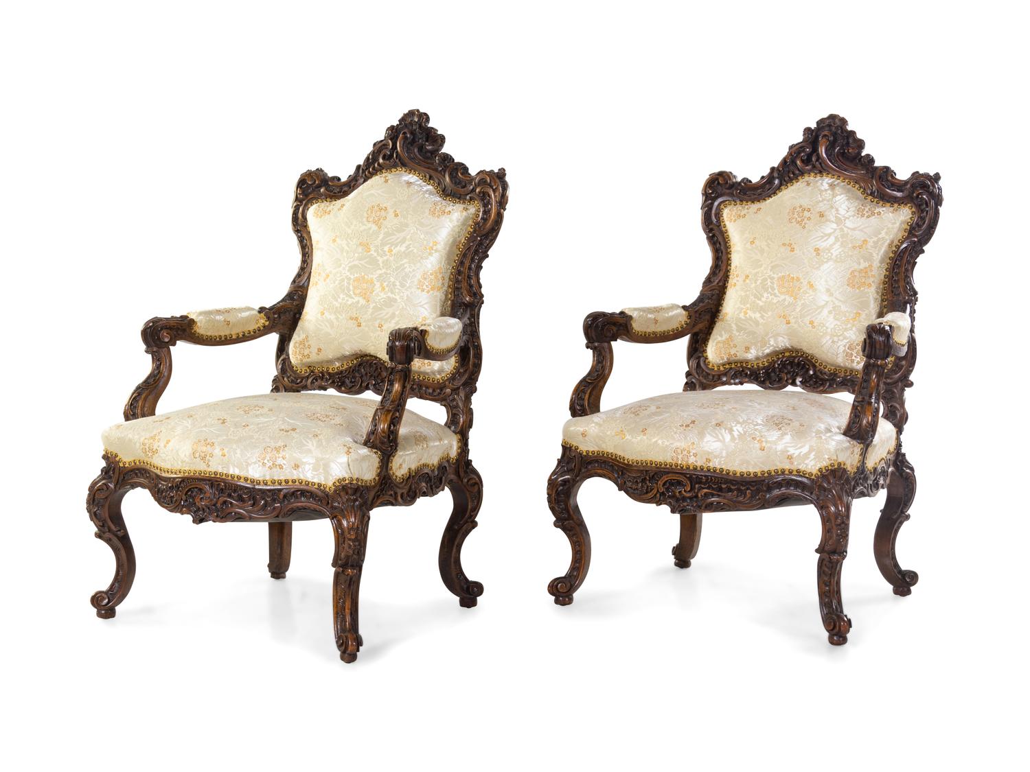 A Pair of Rococo Revival Carved Walnut Fauteuils