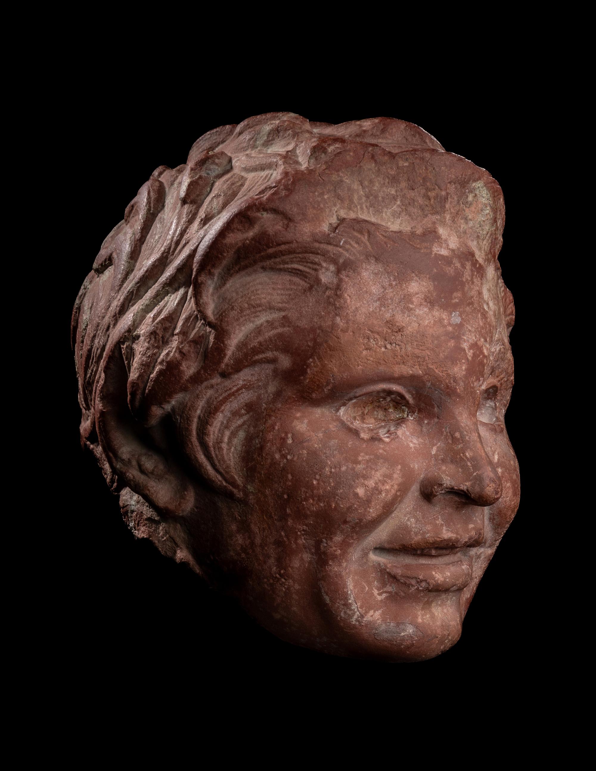 A Roman Rosso Antico Head of a Young Satyr