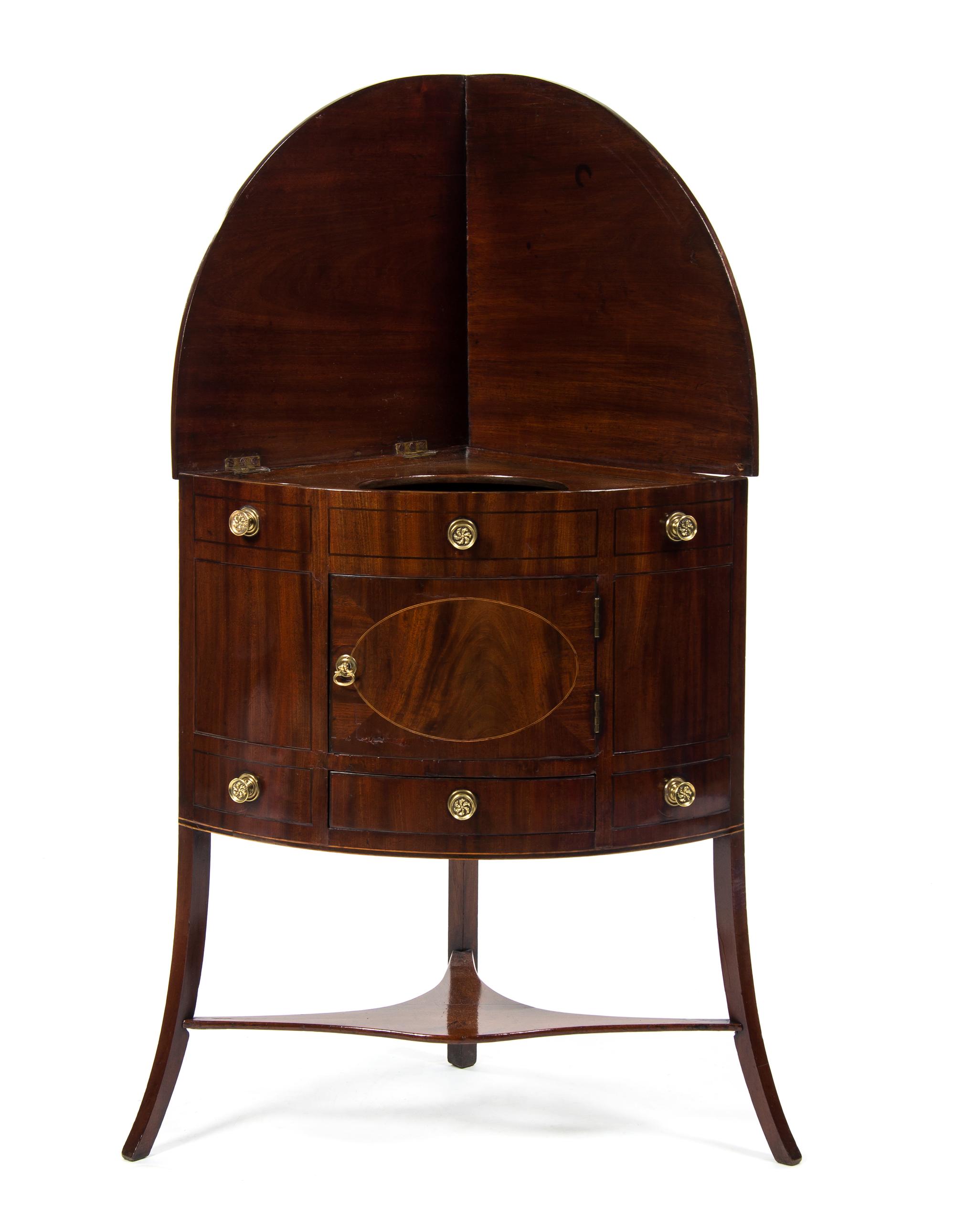 A George III Mahogany Corner Washstand, EARLY 19TH CENTURY, Height 49 x width 26 1/2 x depth 19 inches. — EARLY 19TH CENTURY,