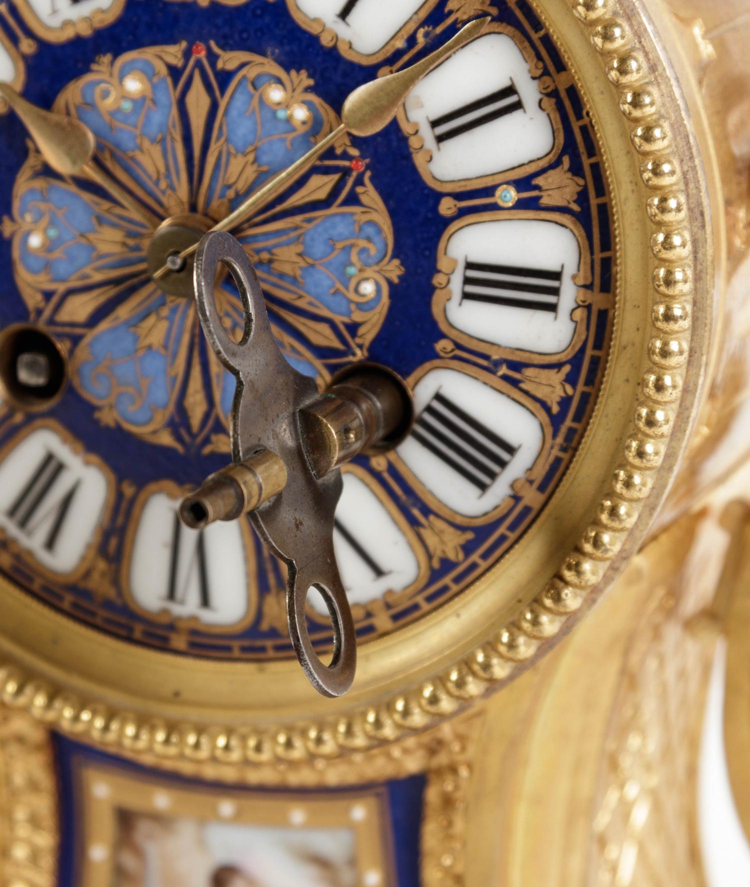 A Louis XVI Style Porcelain Inset Gilt Bronze Mantel Clock