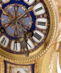 A Louis XVI Style Porcelain Inset Gilt Bronze Mantel Clock