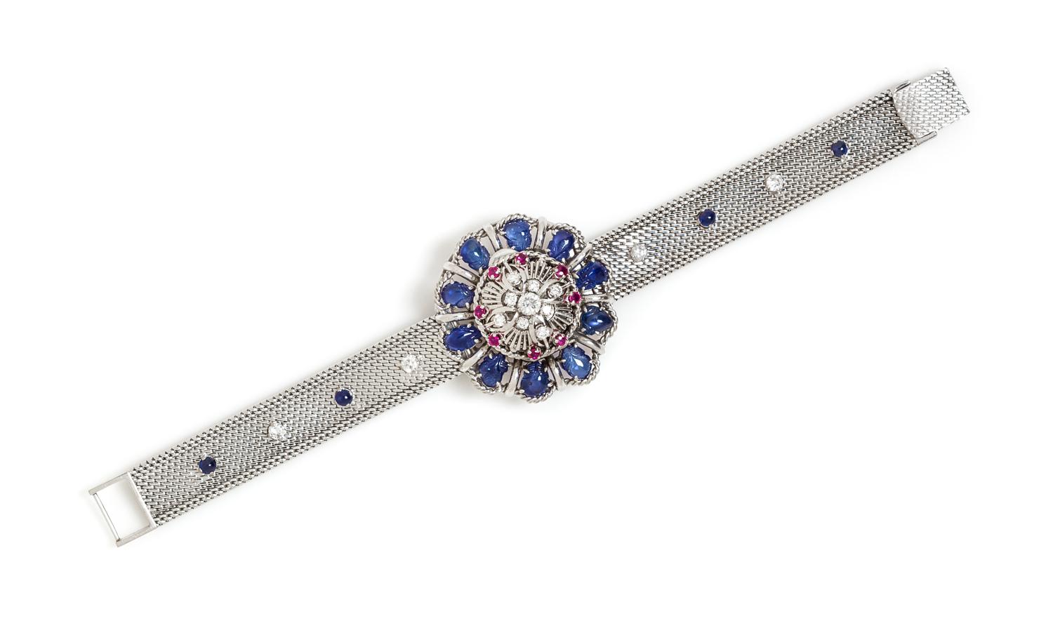 An 18 Karat White Gold, Sapphire, Ruby and Diamond Surprise Wristwatch, 39.10 dwts.
