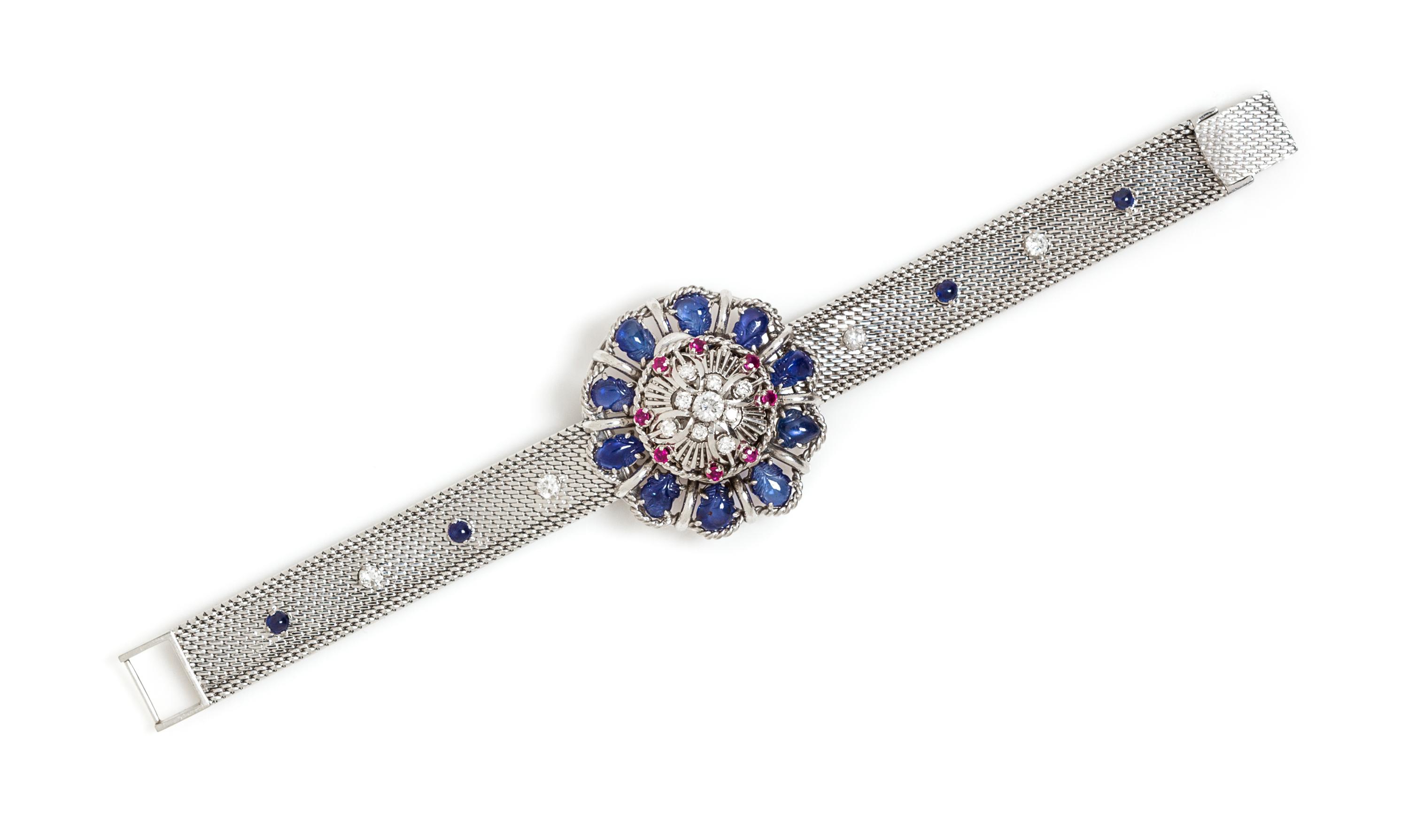 An 18 Karat White Gold, Sapphire, Ruby and Diamond Surprise Wristwatch, 39.10 dwts.