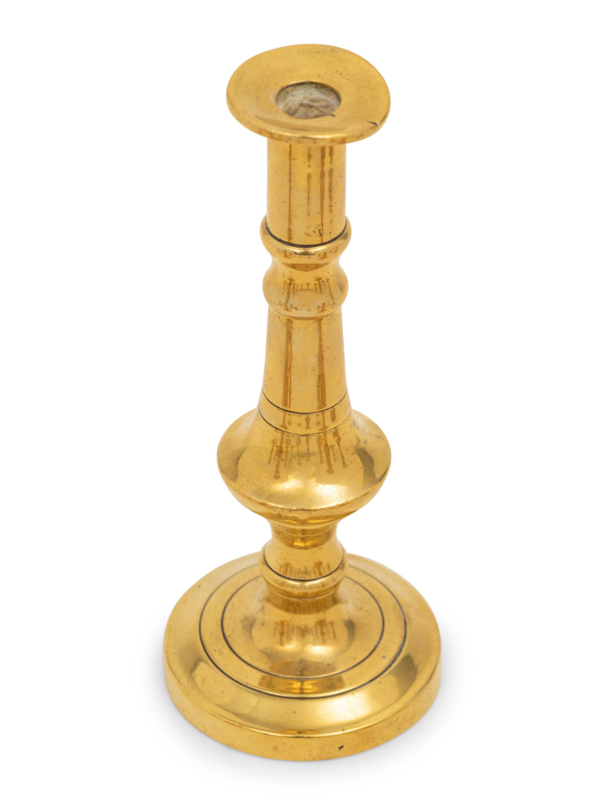 A Collection of Fifteen English Brass Diminutive Candlesticks and Tapersticks