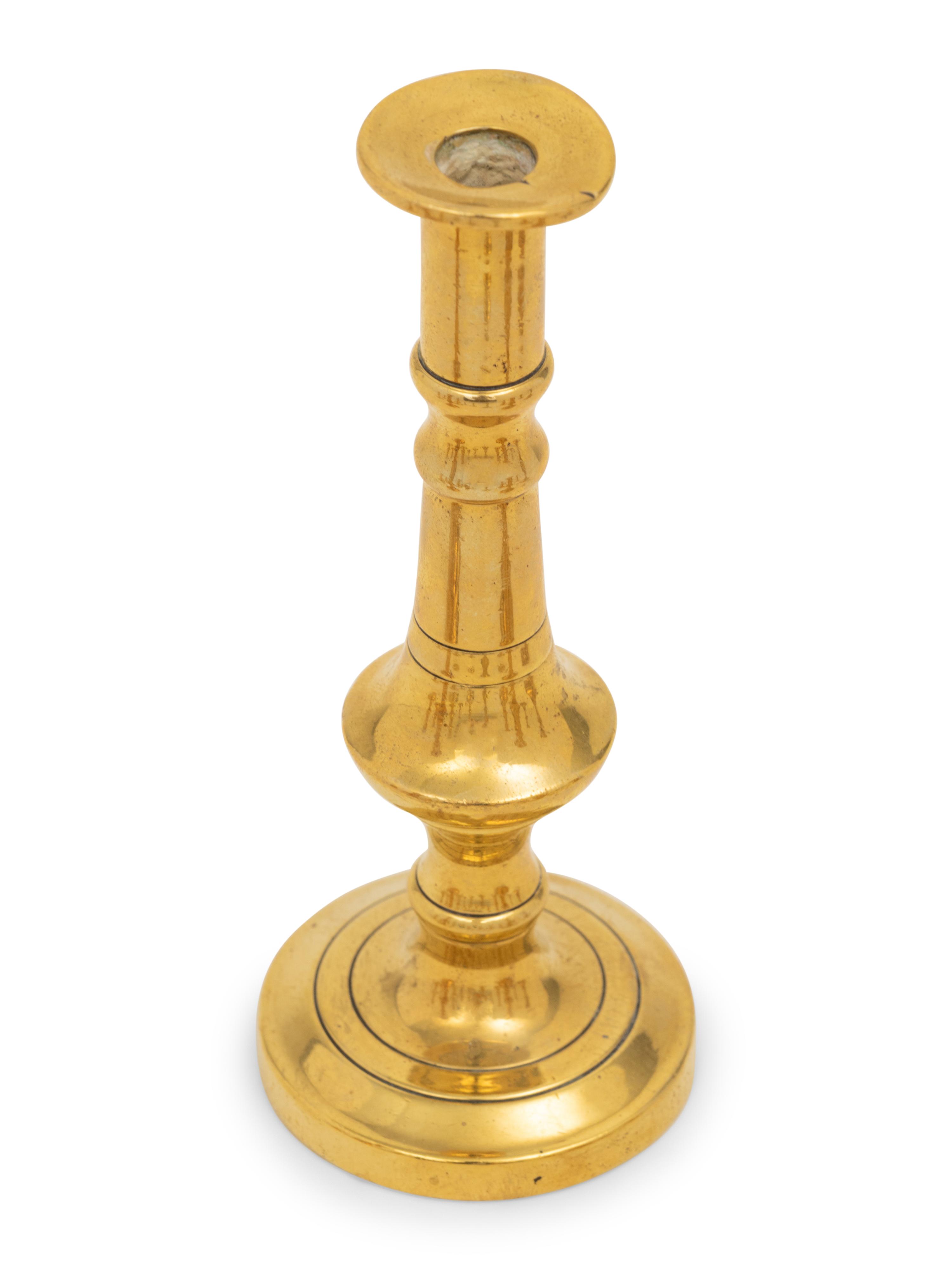 A Collection of Fifteen English Brass Diminutive Candlesticks and Tapersticks