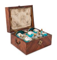 A Sèvres Painted and Parcel Gilt Porcelain Tea and Cordial Service in a Fitted Kingwood and Parquetry Traveling Case