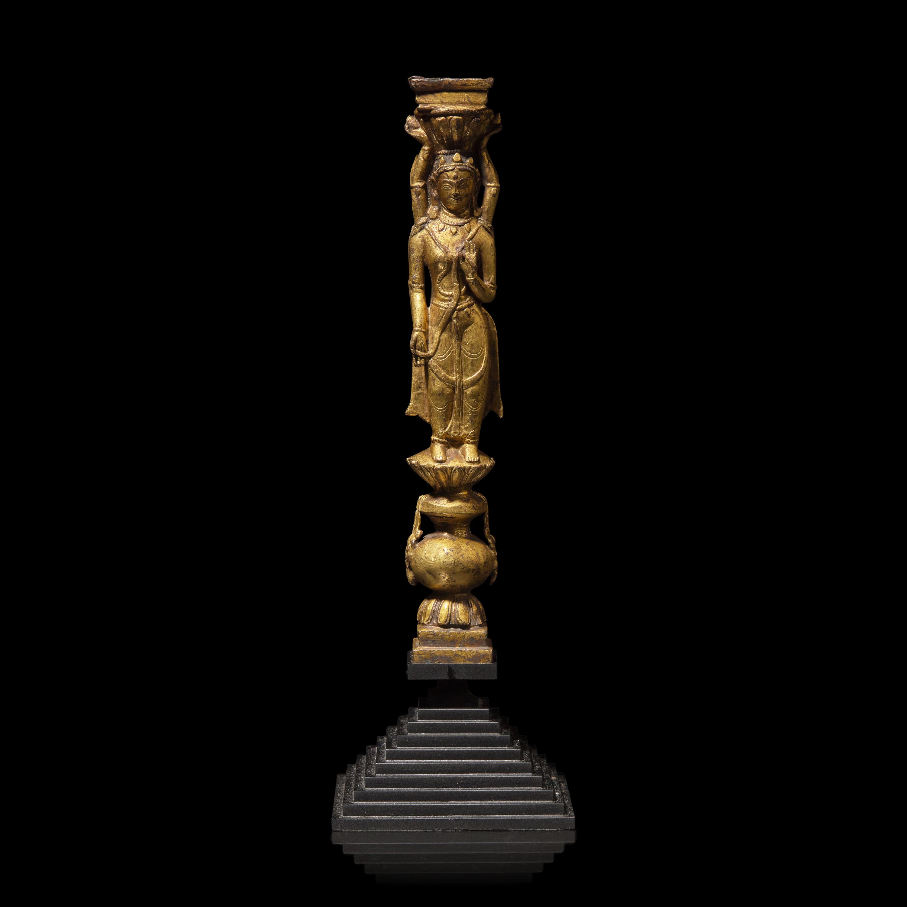 A Tibetan Gilt Copper Alloy Double-Sided Stupa Column Support, Densatil Monastery, 14th/Early 15th Century