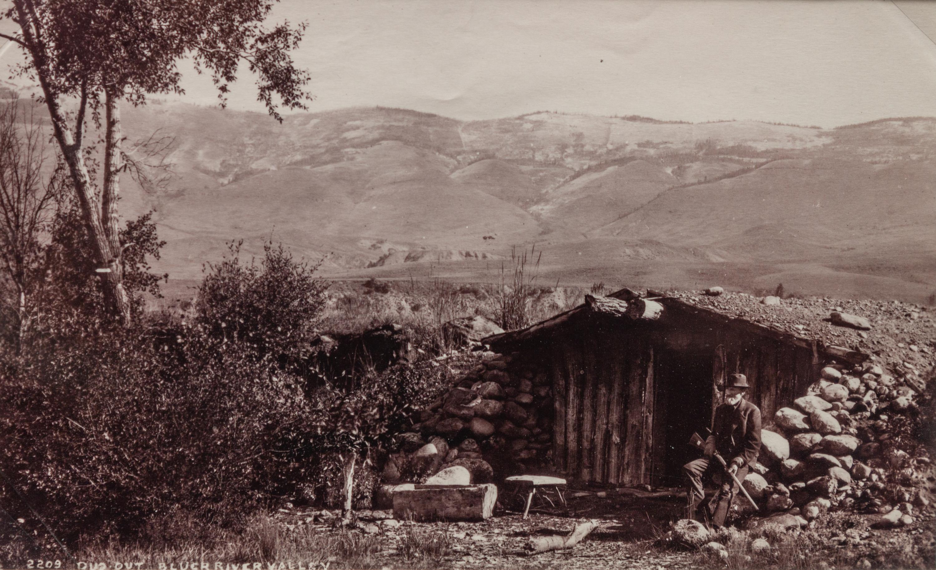 A group of three photographs (3647. Miners at Home; Untitled (main street); 2209. Dug Out - Bluer River Valley)