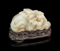 A Pale Celadon Jade 'Qilin and Book' Carving
