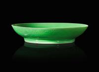 An incised green-glazed "Bajixiang" dish, Yongzheng six-character mark and of the period 暗刻“八吉祥”綠釉盤 雍正六字款 清雍正