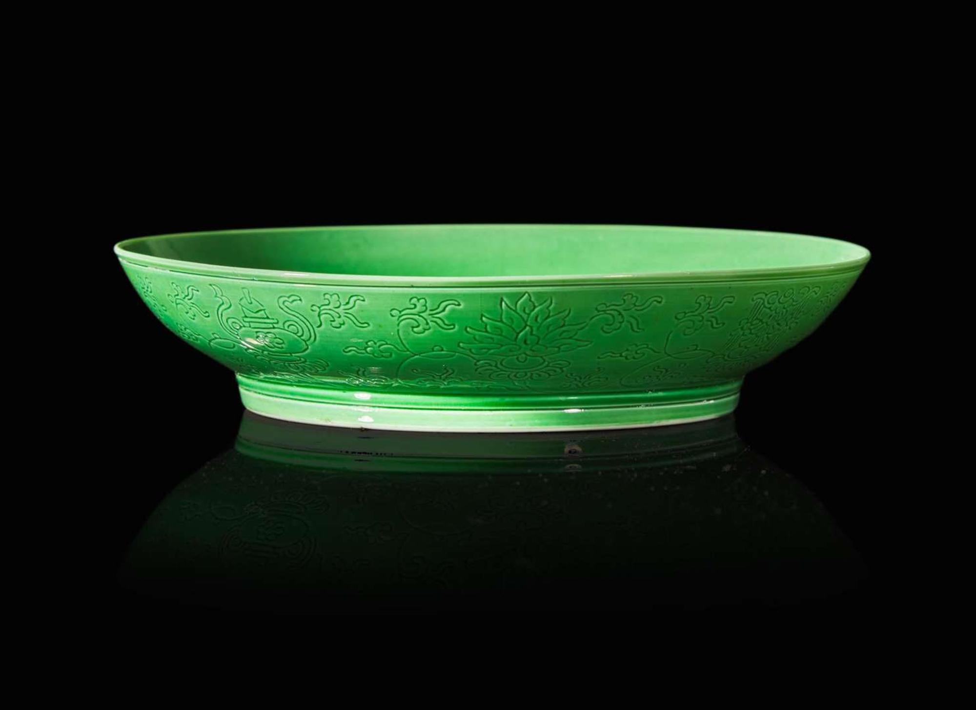 An incised green-glazed "Bajixiang" dish, Yongzheng six-character mark and of the period 暗刻“八吉祥”綠釉盤 雍正六字款 清雍正