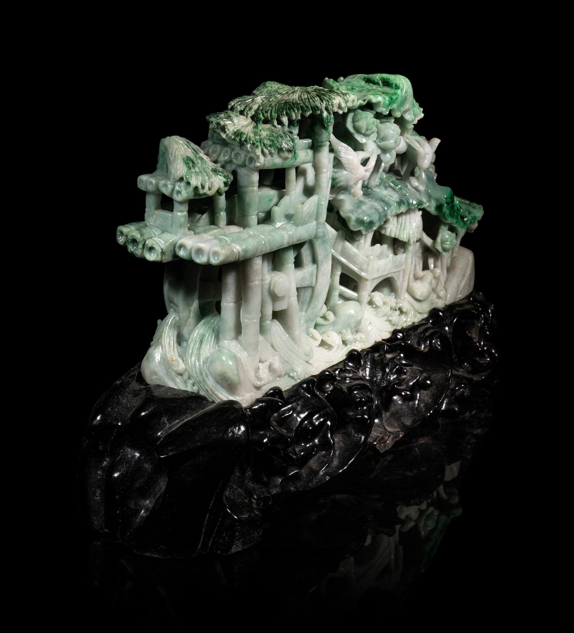 A Large Carved Apple Green and Celadon Jadeite Mountain