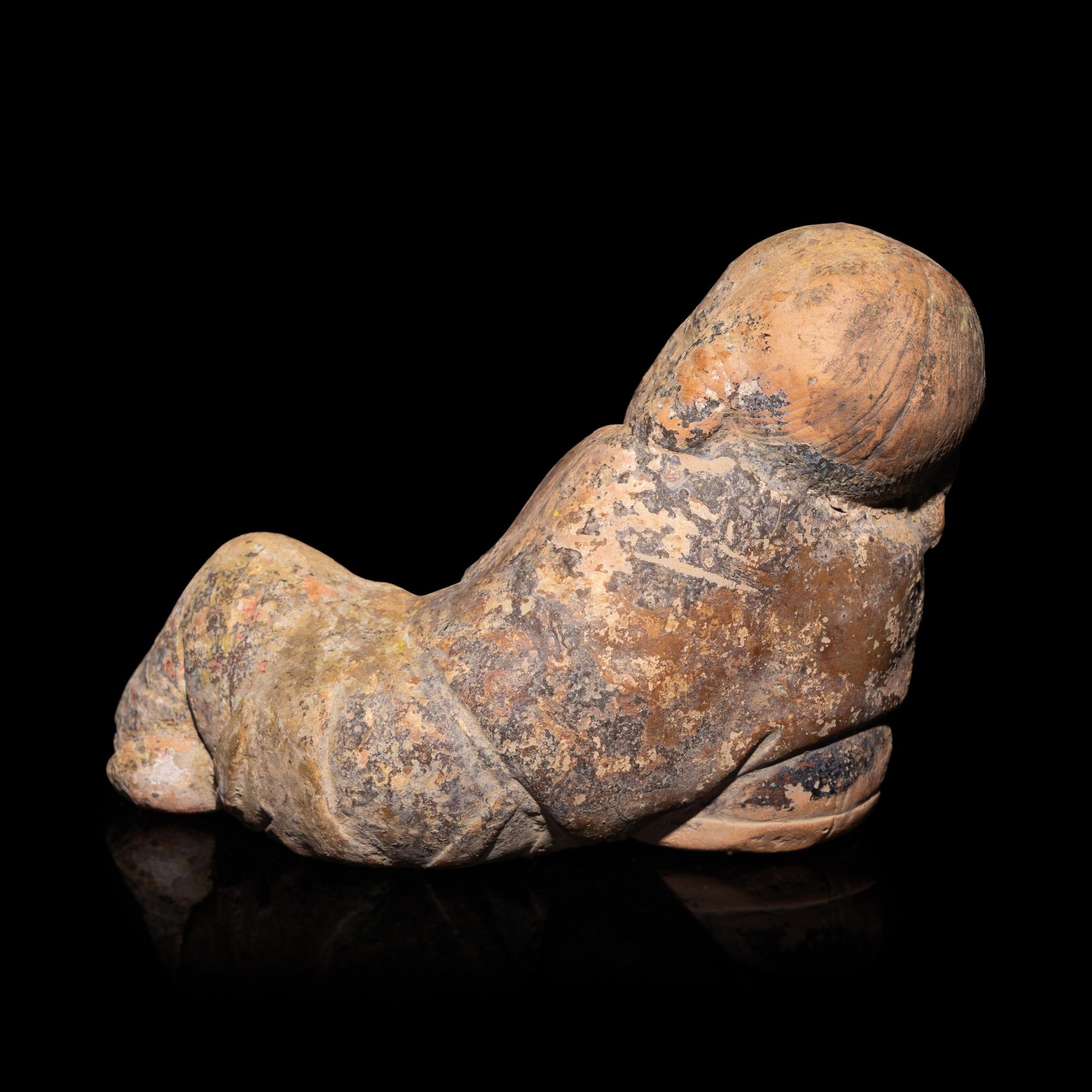 A Chinese Painted Pottery Figure of a Girl, Song Dynasty — 宋 彩繪陶臥女童