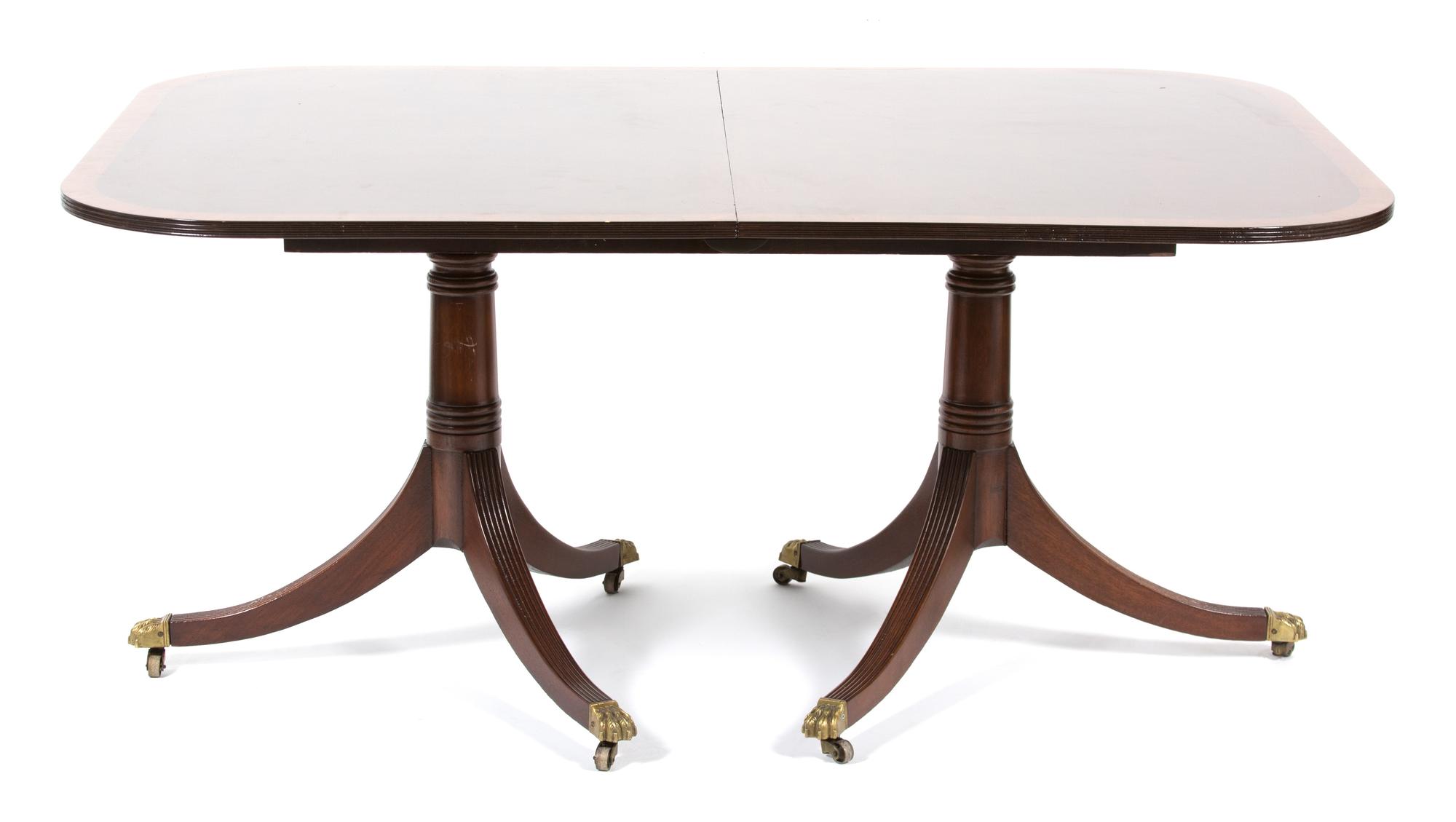 A Georgian Style Pedestal Dining Table Height 28 1/2 x width closed 62 1/2 x depth 45 inches. — 20TH CENTURY
