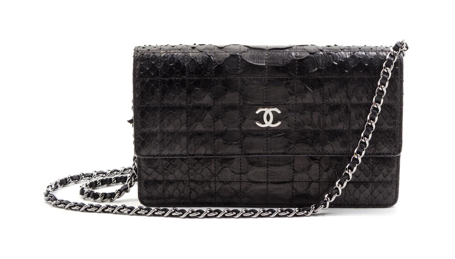 A Chanel Black Python Leather Wallet on a Chain, 8 x 4 1/2 x 1 1/2 inches.
