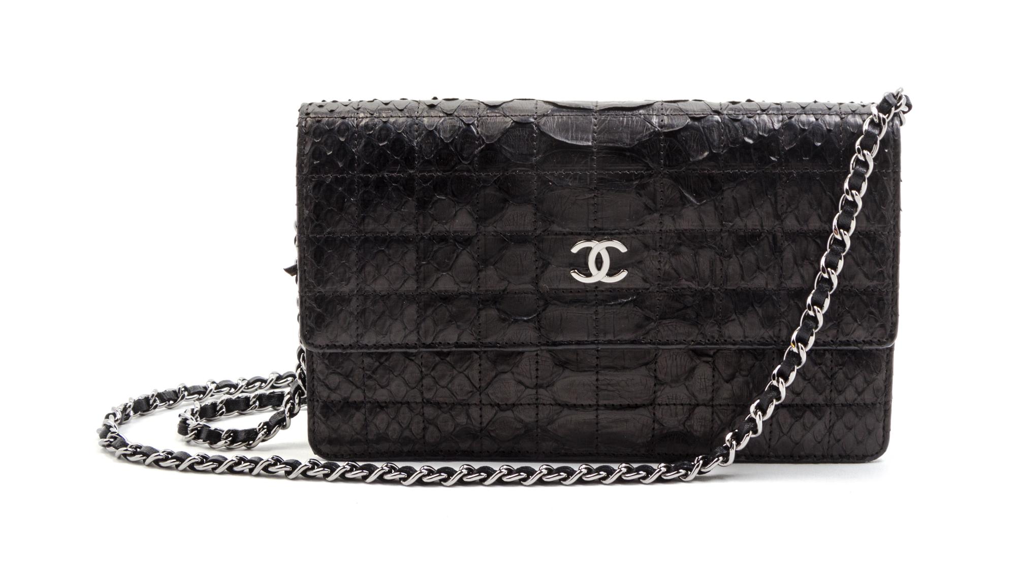 A Chanel Black Python Leather Wallet on a Chain, 8 x 4 1/2 x 1 1/2 inches.