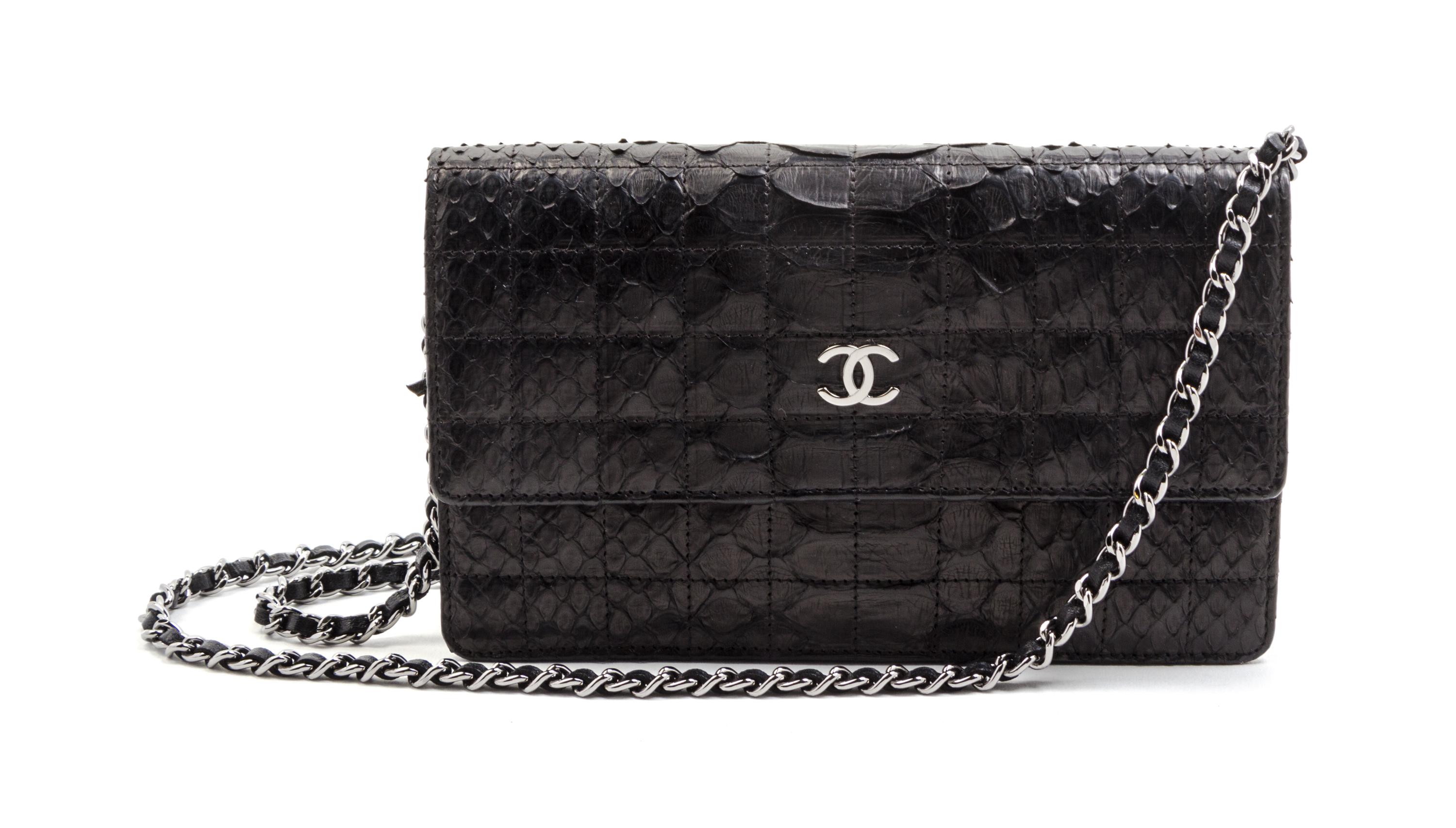 A Chanel Black Python Leather Wallet on a Chain, 8 x 4 1/2 x 1 1/2 inches.