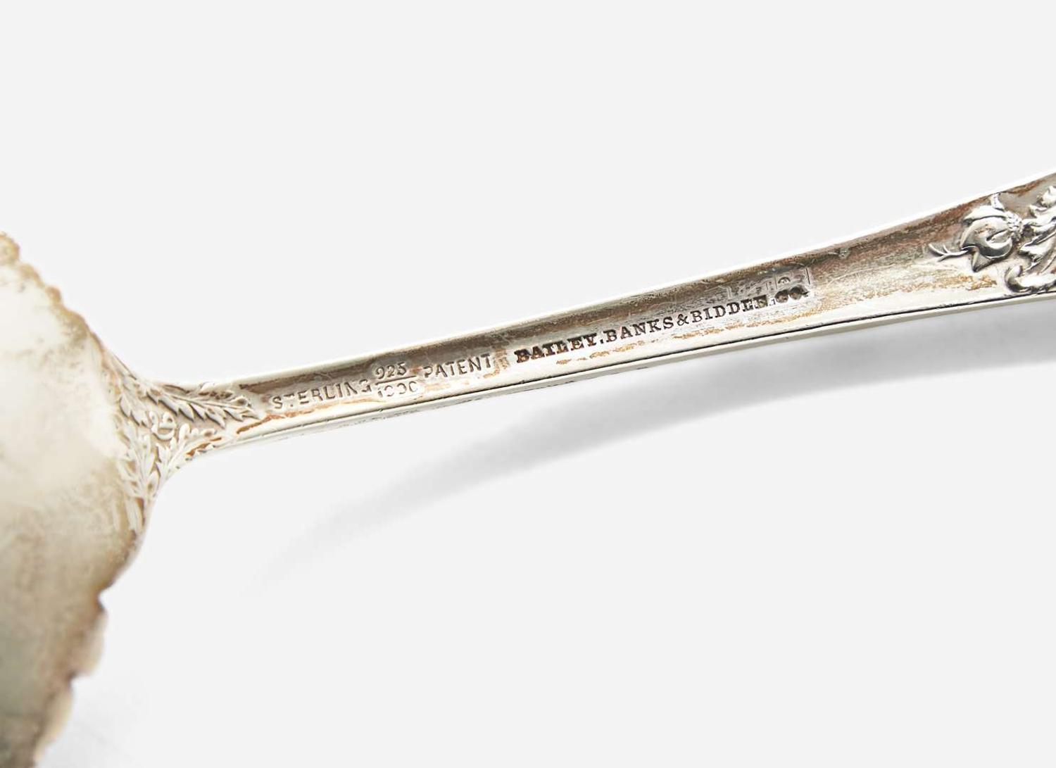 An assembled group of nine sterling silver floral repousse serving utensils, various makers, including Bailey Banks & Biddle Co. and J.E. Caldwell & Co., Philadelphia, PA, and The James R. Armiger Co., Baltimore, MD, and others, late 19th / early 20th century