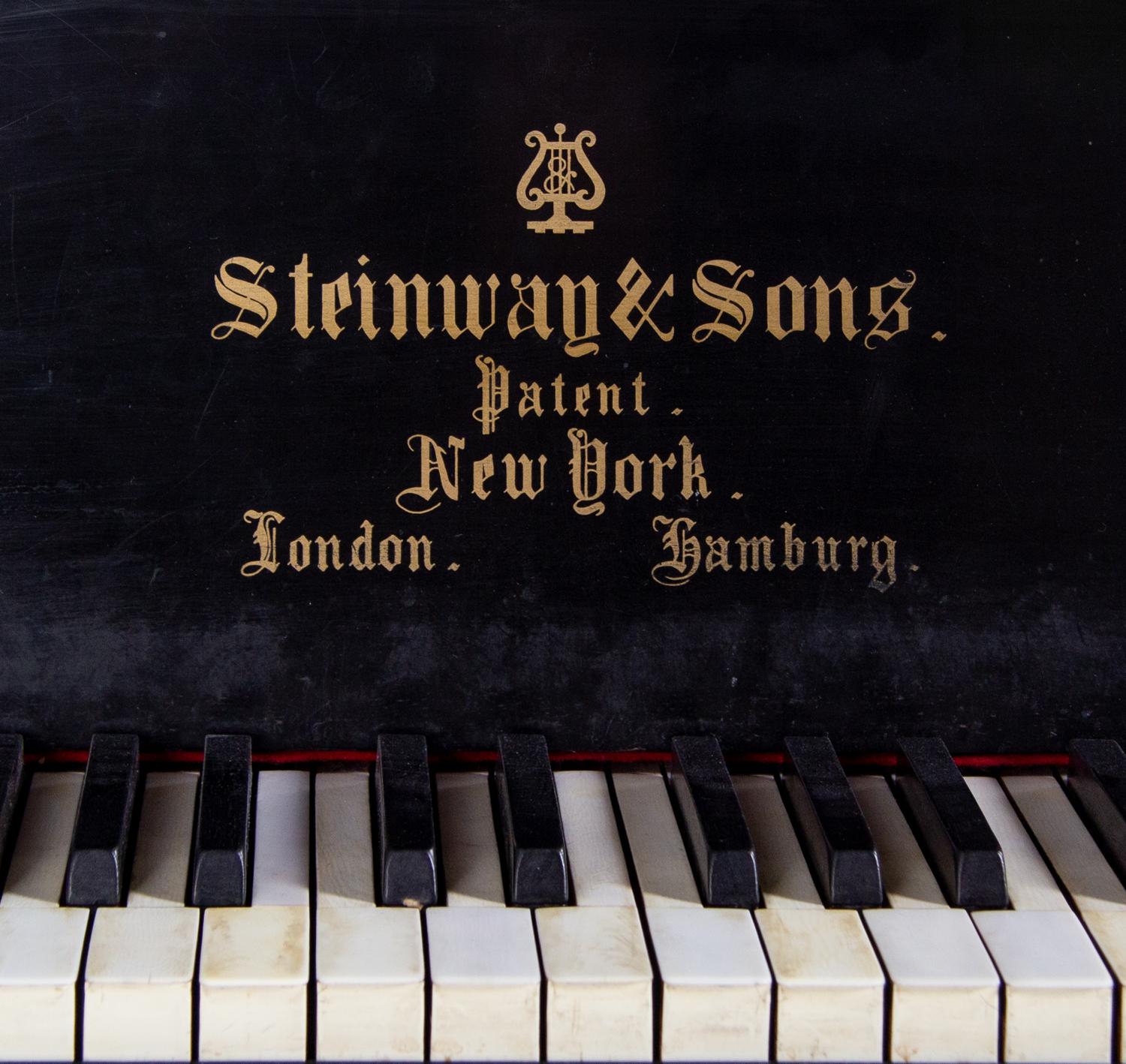 A Steinway and Sons Ebonized Concert Grand Piano
