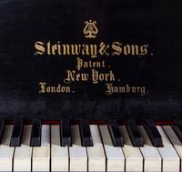 A Steinway and Sons Ebonized Concert Grand Piano