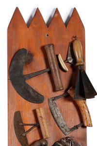 A Collection of Wrought Iron Kitchen Tools Mounted to Panel