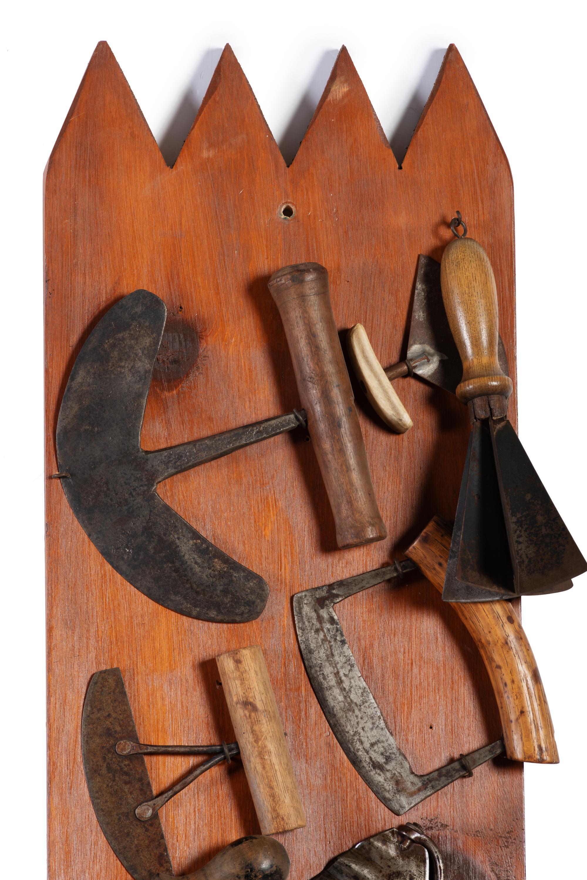 A Collection of Wrought Iron Kitchen Tools Mounted to Panel