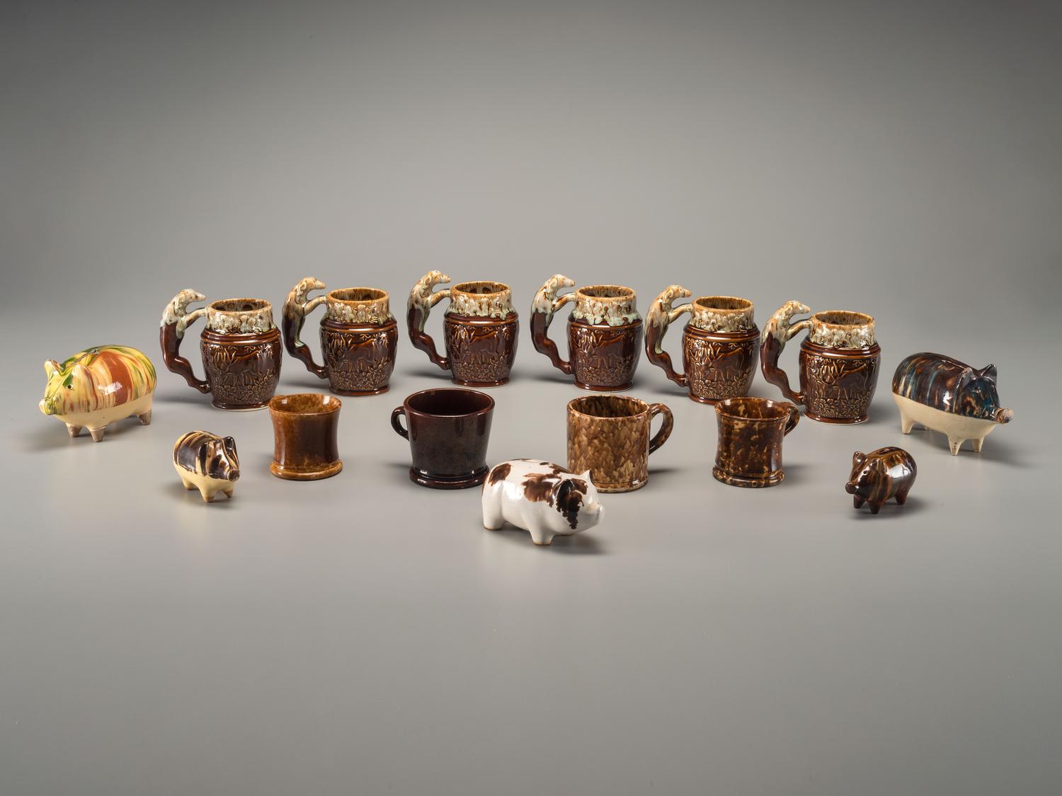 Fifteen Rockingham Glaze Mugs and Pig Banks