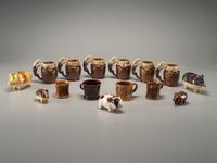 Fifteen Rockingham Glaze Mugs and Pig Banks