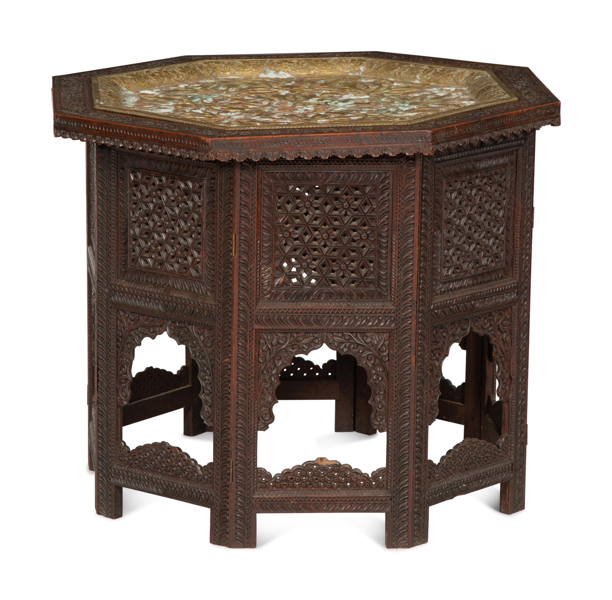 An Anglo-Indian Carved Teak Octagonal Folding Table with Inset Brass Tray Top