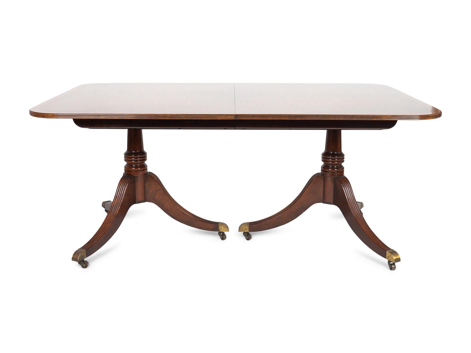 A Regency Style Mahogany Two-pedestal Dining Table by Baker — 20TH CENTURY